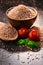 Bowl of uncooked spelt on wooden table