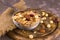 Bowl with useful and nutritious granola on a wooden board.