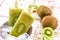 Bowl of vanilla and kiwi yogurt popsicles on a white rustic wooden background  unsweetened ice cream  natural homemade