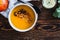 Bowl with vegan pumpkin and chickpea cream soup on wooden table, directly above