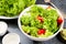 Bowl with vegetable salad on dark stone table with centimeter, diet concept