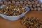 A bowl with walnut kernels and a lot of walnuts folded in the form of a prism