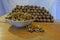 A bowl with walnut kernels and a lot of walnuts folded in the form of a prism