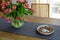 Bowl with walnuts and vase with tulips on wooden table indoors