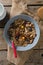 Bowl of wheat flakes, blueberry and golden berry with milk jug