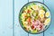 Bowl with wheat porridge, boiled quail eggs and fresh vegetable salad of radish, corn, sweet pepper and chinese cabbage. Healthy a