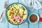 Bowl with wheat porridge, boiled quail eggs and fresh vegetable salad of radish, corn, sweet pepper and chinese cabbage. Healthy a