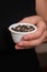 Bowl of Whole Peppercorns in a Female Hand. Gently holding a ramekin filled with assorted whole peppercorns