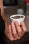 Bowl of Whole Peppercorns in a Female Hand. Gently holding a ramekin filled with assorted whole peppercorns