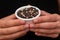 Bowl of Whole Peppercorns in a Female Hands. Gently holding a ramekin filled with assorted whole peppercorns