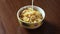 Bowl on wood table full of cornflakes soaked in milk, high definition FullHD