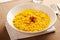 Bowl of yellow risotto rice with saffron threads