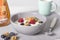 Bowl of yoghurt with fresh raspberries, blueberries and nuts