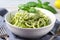 bowl of zucchini noodles, topped with creamy pesto sauce