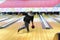 Bowler throw the ball at the bowling lane