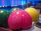 Bowling background. Interior of bowling alley lane with balls return machine closeup, selective focus on blue ball