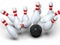 Bowling ball hitting all pins scoring strike, action shot, white background