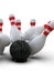 Bowling ball hitting all pins, in a Strike, light background