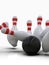 Bowling ball hitting all pins, in a Strike, light background