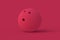 Bowling ball of magenta on red background. Color of the year 2023