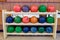 Bowling ball multi color row on wood rack