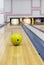 Bowling ball rolling toward pins