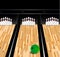 Bowling ball and skittle on wooden floor