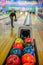 Bowling balls and player on blurred background