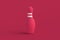 Bowling pin of magenta on red background. Color of the year 2023