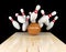 Bowling strike, scattered skittle and bowling ball on bowling lane with motion blur on bowling ball