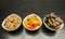 Bowls with additions to cakes and desserts: dried dates, candied pineapple and shelled almonds.
