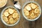 Bowls of banana walnut oatmeal on wood