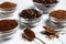 Bowls of beans, instant and ground coffee on white marble table, closeup