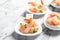 Bowls with boiled shrimps and sauce