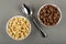 Bowls with cereal breakfasts with chocolate and caramel, spoon on table. Top view