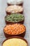 Bowls of cereal grains. Selective focus on red lentils.
