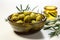 Bowls containing olives and adorned with rustic olive branch twigs on white