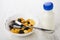 Bowls with corn flakes, dried apricots, raisins, prunes and spoon