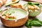 Bowls with delicious green vegetable creamy soup with croutons.