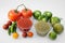 Bowls with delicious salsa sauces and ingredients on white background