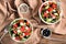 Bowls with delicious watermelon salad on table, top view