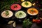 Bowls with different kinds of hummus on dark wooden background, Assortment of colored vegetable cream soups, Dietary food, soup