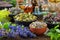 Bowls of dry medicinal herbs - mistletoe, wild marjoram, heather. Calendula flowers, bilberry twigs and bugleherb flowers.