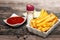 Bowls with french fries, tomato sauce and mayonnaise with bottle