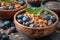 Bowls of granola- blueberries- black chia seeds.