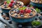 Bowls of granola- blueberries- black chia seeds.