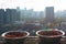 Bowls of ground red pepper drying on a building rooftop