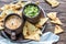 Bowls of guacamole and queso with tortilla chips