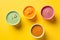 Bowls with healthy baby food on a yellow background, healthy food concept, Generative AI