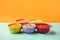 Bowls with healthy baby food on a yellow blue background, healthy food concept, Generative AI